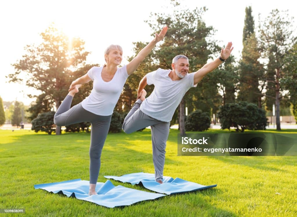 Active seniors practicing balance therapy outdoors
